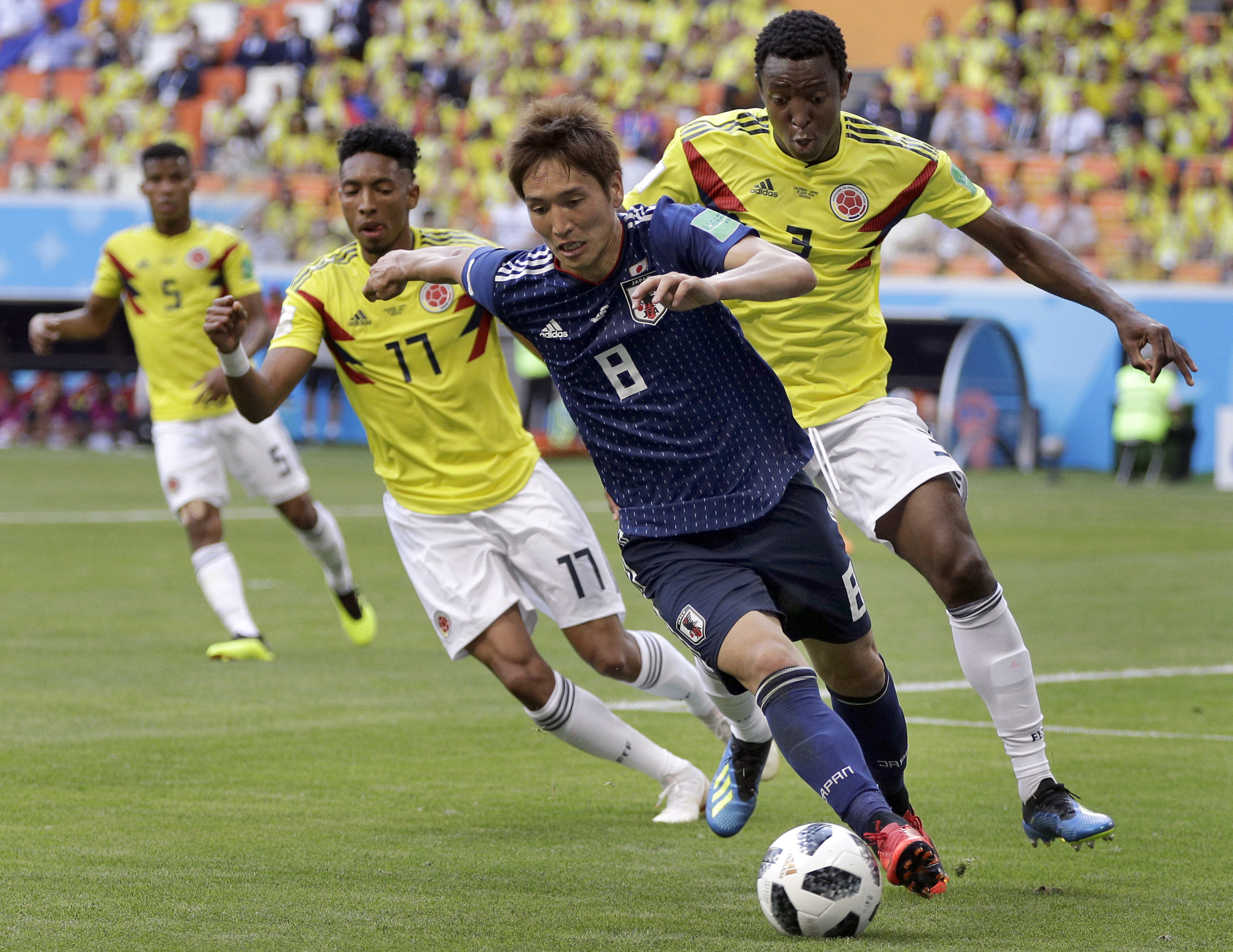 Genki Haraguchi dribbles the ball during Japan's 2-1 win over Colombia on Tuesday at the 2018 World Cup in Saransk, Russia. | AP