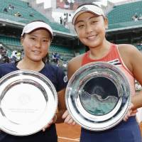 French Open women\'s doubles runners-up Makoto Ninomiya (left) and Eri Hozumi pose for photos after the final on Sunday in Paris. | KYODO
