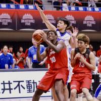 Japan forward Evelyn Mawuli attempts a shot underneath the basket against Taiwan on Friday night. | KAZ NAGATSUKA