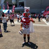 Yoshiharu Okuyama, a 54-year-old fan from Saitama Prefecture, stands outside Noevir Stadium in Kobe before the Japan-Italy game on Saturday. | ANDREW MCKIRDY
