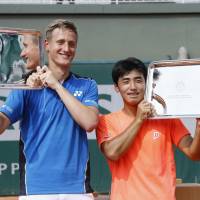 Naoki Tajima (right) and Ondrej Styler celebrate after winning the boys\' doubles title at the Roland Garros Junior French Championships on Saturday in Paris. | KYODO