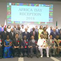 Deputy Prime Minister Taro Aso (front center) poses for a photo with Eritrean Ambassador Afeworki Haile Estifanos (sixth from right) and other African ambassadors at a reception to celebrate Africa Day in Tokyo\'s Minato Ward on May 25. | MINORU MATSUTANI