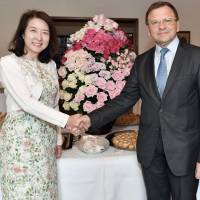 Bulgarian Rose Cultural Association Chief Director Fumie Yamashita (left) poses for a picture with Bulgarian Ambassador Borislav Kostov (center) and his wife, Manya, at the Rose Day Charity Party at the ambassador\'s residence in Tokyo on May 31. | YOSHIAKI MIURA