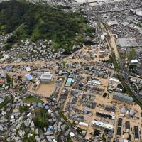 The town of Saka, Hiroshima Prefecture, is flooded in this photo taken from a Kyodo News helicopter Saturday morning. | KYODO