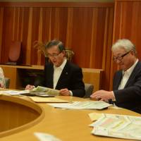 Maniwa Mayor Noboru Oota (center) explains the city\'s satoyama efforts during a Japan Times study tour on June 8. | SHINOBU YAMADA