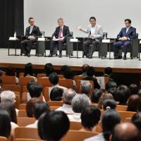 Panelists discuss health and productivity management at the symposium. | YOSHIAKI MIURA