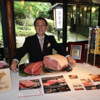 Tottori Gov. Shinji Hirai with blocks of premium Tottori Wagyu during an interview at Seisen-tei restaurant at Hotel New Otani Tokyo on June 17. | MASAAKI KAMEDA