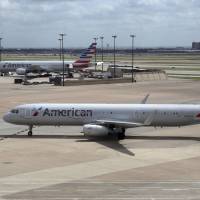 American Airlines aircraft are seen at Dallas-Fort Worth International Airport in Grapevine, Texas, June 16. American Airlines says it will stop using plastic straws and drink stirs and replace them with biodegradable alternatives. American said Tuesday that starting this month in its airport lounges it will serve drinks with straw and wood stir sticks and begin moving to what it called eco-friendly flatware. | AP