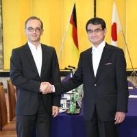 Foreign Minister Taro Kono shakes hands Wednesday with German Foreign Minister Heiko Maas ahead of their meeting at the Iikura Guesthouse in Tokyo. | KYODO