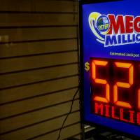 A sign displays that the Mega Millions Lottery prize is estimated at &#36;522 million, before the drawing, at a newsstand in the Brooklyn borough of New York City Tuesday. | REUTERS