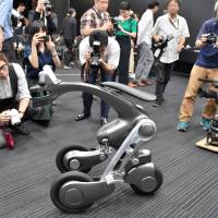 The CanguRo three-wheeler robot, developed by Chiba Institute of Techonolgy, is presented to the media Wednesday at the university\'s Tokyo campus. Fused with AI technologies, the robot can complete a wide variety of tasks. | YOSHIAKI MIURA