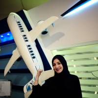 Dalia Yashar, one of the first Saudi students who registered to become a commercial pilot, stands in front of the registration center, CAE Oxford ATC, where Saudi women can pursue a carrier as a commercial pilot, at King Fahd International Airport in Dammam, Saudi Arabia, Sunday. | REUTERS