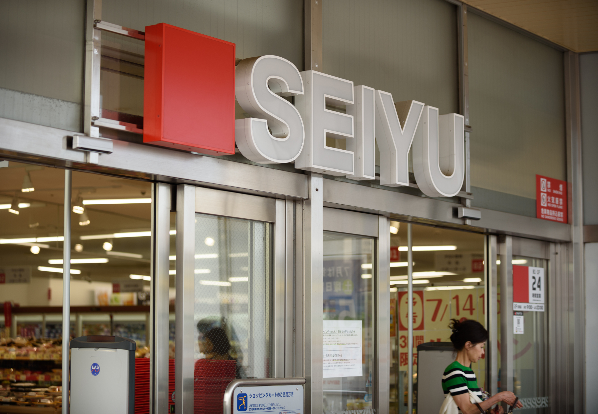 A customer exits a Seiyu store in Tokyo on Thursday. | BLOOMBERG