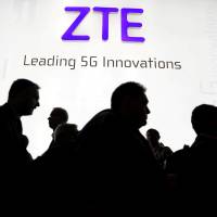 Visitors pass in front of the Chinese telecoms equipment group ZTE Corp. booth at the Mobile World Congress in Barcelona, Spain, in February. | REUTERS