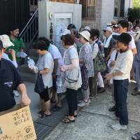 Peace Winds Japan volunteers distribute water in an afflicted area. | COURTESY OF PEACE WINDS JAPAN