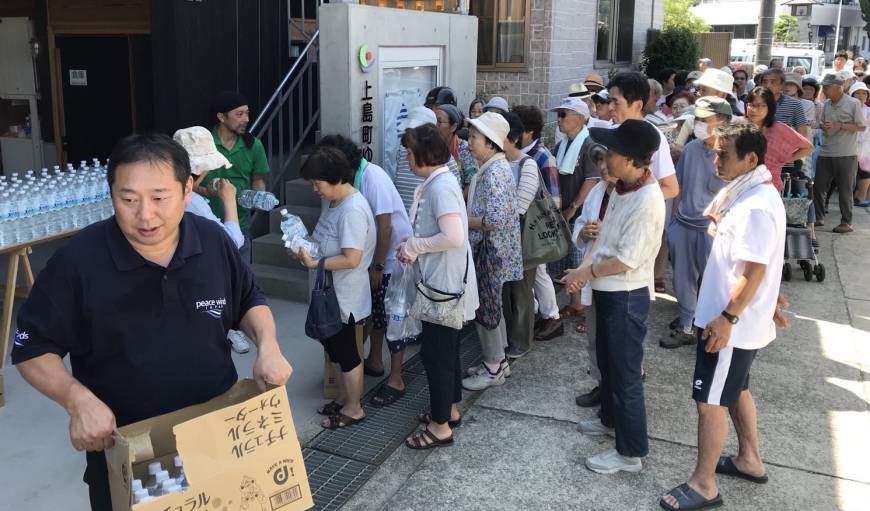 Peace Winds Japan volunteers distribute water in an afflicted area.