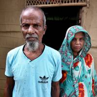 Abdul Suban and his wife outside their home in the Assam village of Nellie in India\'s northeastern state of Assam on Wednesday. | REUTERS