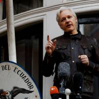 WikiLeaks founder Julian Assange is seen on the balcony of the Ecuadorian Embassy in London in May 2017. | REUTERS
