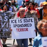 People march during a \"Free Our Future\" demonstration to protest the expected introduction of the U.S. Department of Justice and Immigration Customs Enforcement\'s new sped-up mass immigration hearings and deportations in San Diego, California, Monday. | REUTERS