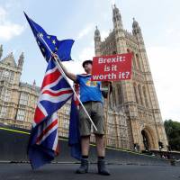 A man holds an anti-Brexit banner on Westminster Bridge, in central London, on July 13. | REUTERS