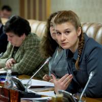 Public figure Maria Butina (right) attends a meeting of a group of experts, affiliated with the government of Russia, in this undated handout photo obtained by Reuters on Tuesday. | PRESS SERVICE OF CIVIC CHAMBER OF THE RUSSIAN FEDERATION / HANDOUT / VIA REUTERS