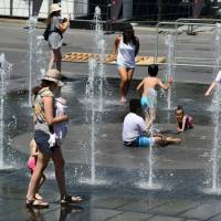 Women and children play in the water fountains at the Place des Arts in Montreal Tuesdayon a hot summer day. A heatwave in Quebec has killed at least 17 people in the past week as high summer temperatures scorched eastern Canada, health officials said on Wednesday. Twelve of the dead were reported in the eastern province\'s capital Montreal, said regional public health director Mylene Drouin. | AFP-JIJI