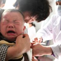 A child receives a vaccination at a hospital in Huaibei in China\'s eastern Anhui province on Thursday. | AFP-JIJI