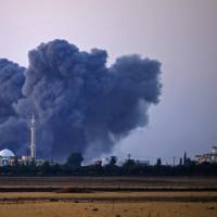 Smoke rises above rebel-held areas of the city of Saida, some 10 km east of Daraa, during reported airstrikes by Syrian regime forces on Wednesday. Syria\'s southern province of Daraa, one of the last rebel bastions, has been the target of a deadly regime offensive since June 19 that has forced around 300,000 people to flee. | AFP-JIJI