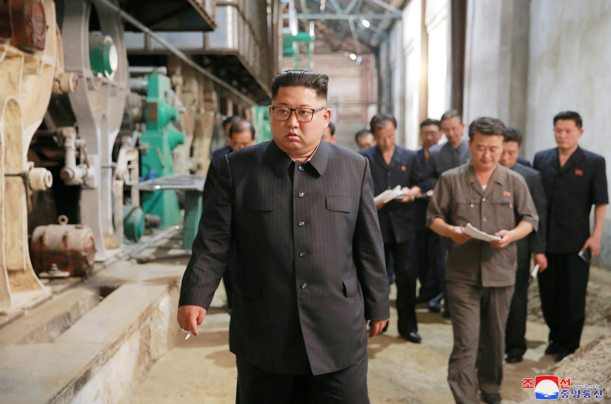 In this undated photo released on July 2, Supreme Leader Kim Jong Un is seen touring a factory in Sinuiju, a North Korean town opposite the Chinese border city of Dandong. | REUTERS