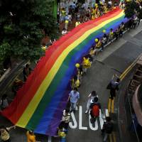 Participants march with a rainbow banner during the annual pride parade in Hong Kong in 2015. | REUTERS