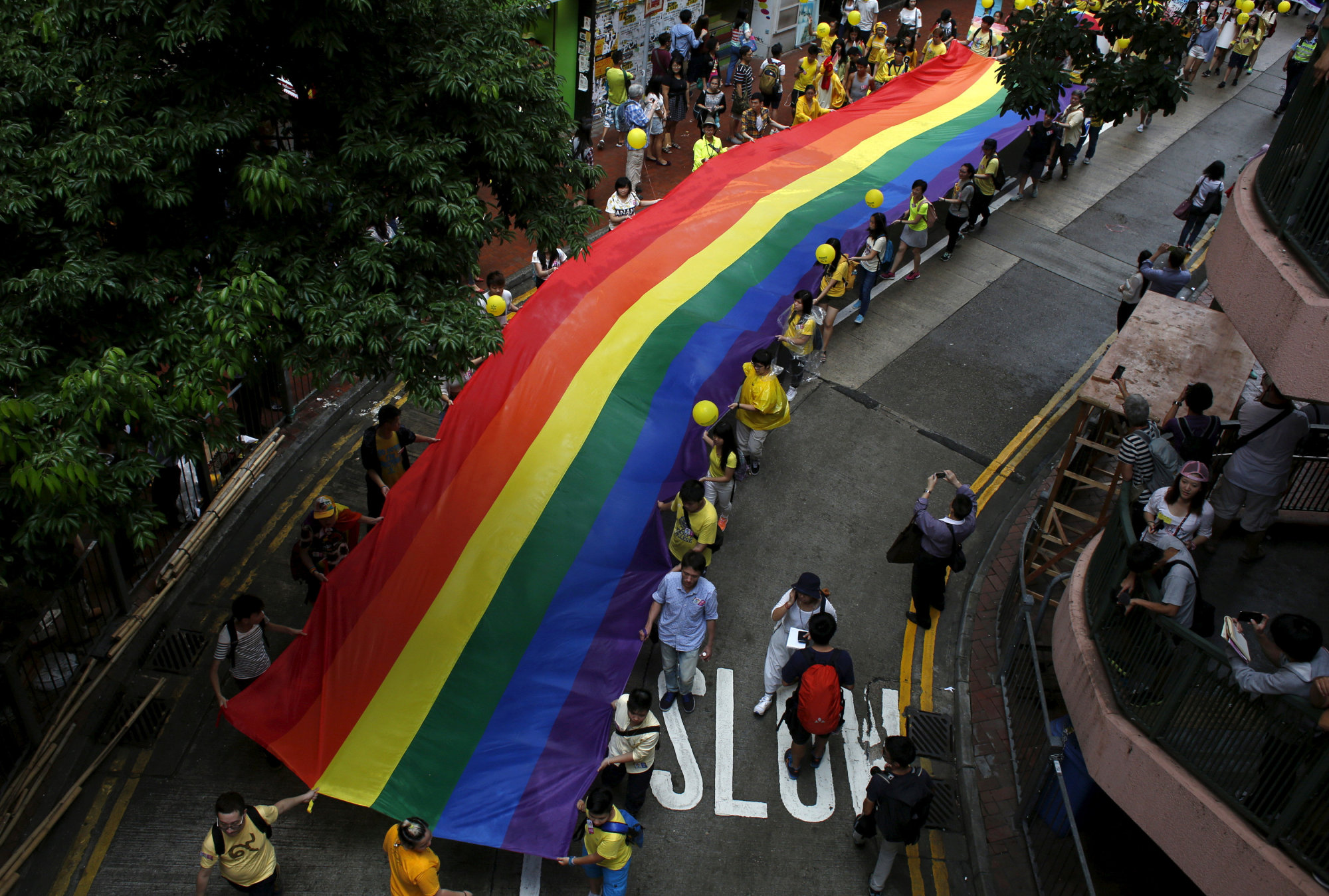 Participants march with a rainbow banner during the annual pride parade in Hong Kong in 2015. | REUTERS