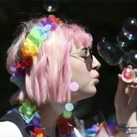 A woman blows bubbles during the Pride Parade in Dublin on June 30. | PA / VIA AP