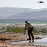 Israeli forces search the Sea of Galilee coast for the remains of a reported drone launched from Syria and intercepted by a Patriot missile on Wednesday. | AFP-JIJI