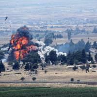 An explosion is seen in Quneitra on the Syrian side of the Israeli Syrian border as viewed from the Israeli-occupied Golan Heights Sunday. | REUTERS
