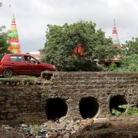 A man drives past the site where Mohammed Azam was killed in a mob lynching attack in Murki village in Bidar, India, July 19. | REUTERS
