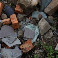 A destroyed part of a car windshield is seen among the stones and bricks at the site where Mohammed Azam was killed in a mob lynching in Murki village in Bidar, India, July 19. | REUTERS