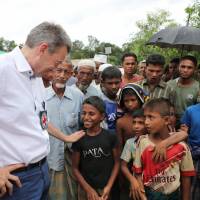 Peter Maurer, president of the International Committee of the Red Cross (ICRC), interacts with Rohingya children during his visit to a refugee camp in Cox\'s Bazar, Bangladesh, Sunday. | REUTERS