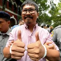 Detained Reuters journalist Wa Lone is escorted by police while leaving Insein court in Yangon July 2. | REUTERS