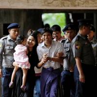 Detained Reuters journalist Kyaw Soe Oo arrives at Insein court in Yangon July 2. | REUTERS