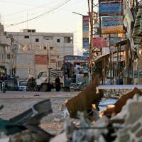 A picture taken on Tuesday shows damage in a street caused by regime airstrikes, in the rebel-held town of Nawa, about 30 km north of Daraa in southern Syria. | AFP-JIJI