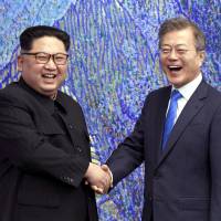 North Korean leader Kim Jong Un poses with South Korean President Moon Jae-in for a photo inside the Peace House at the border village of Panmunjom in the Demilitarized Zone on April 27. | AP