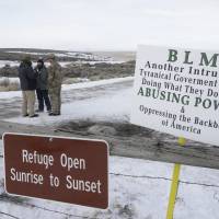 Members of the group occupying the Malheur National Wildlife Refuge headquarters stand guard near Burns, Oregon, in 2016. President Donald Trump on Tuesday pardoned two cattle ranchers convicted of arson in a case that sparked the armed occupation of the national wildlife refuge in Oregon. | AP