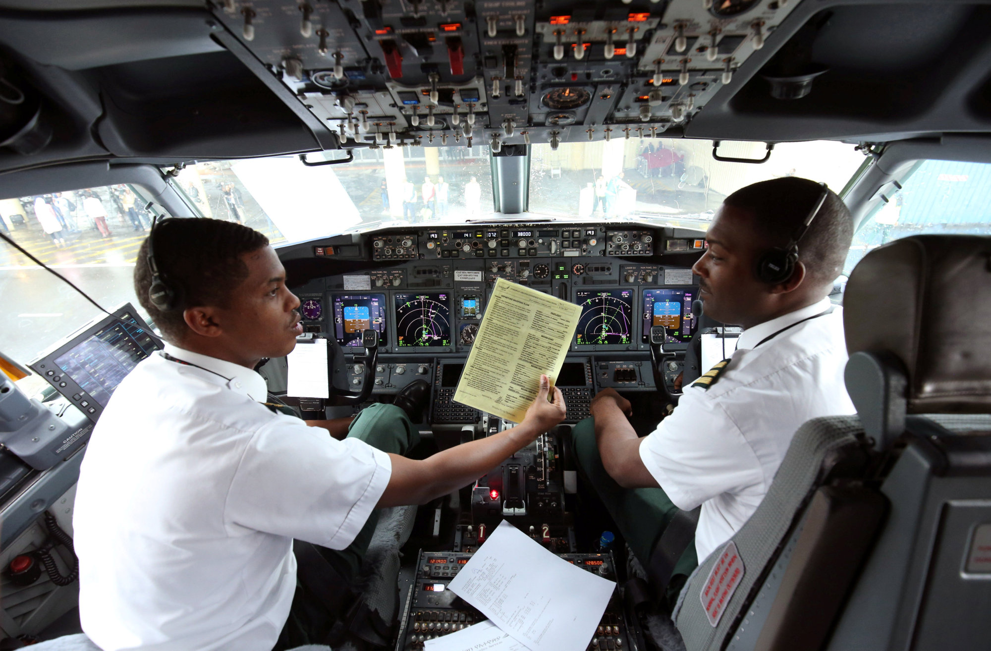 Pilots sit in the cockpit as they prepare Ethiopian Airlines ET314 flight to Eritrea's capital Asmara at the Bole International Airport in Addis Ababa Wednesday. | REUTERS