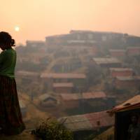 A Rohingya refugee is seen in Balukhali refugee camp at dawn near Cox\'s Bazaar, Bangladesh, March 28. | REUTERS