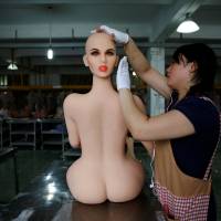 A worker assembles a sex doll at the WMDOLL factory in Zhongshan, Guangdong Province, China, on July 11. | REUTERS