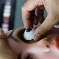 A worker assembles a sex doll at the WMDOLL factory in Zhongshan, Guangdong Province, China, on July 11. | REUTERS