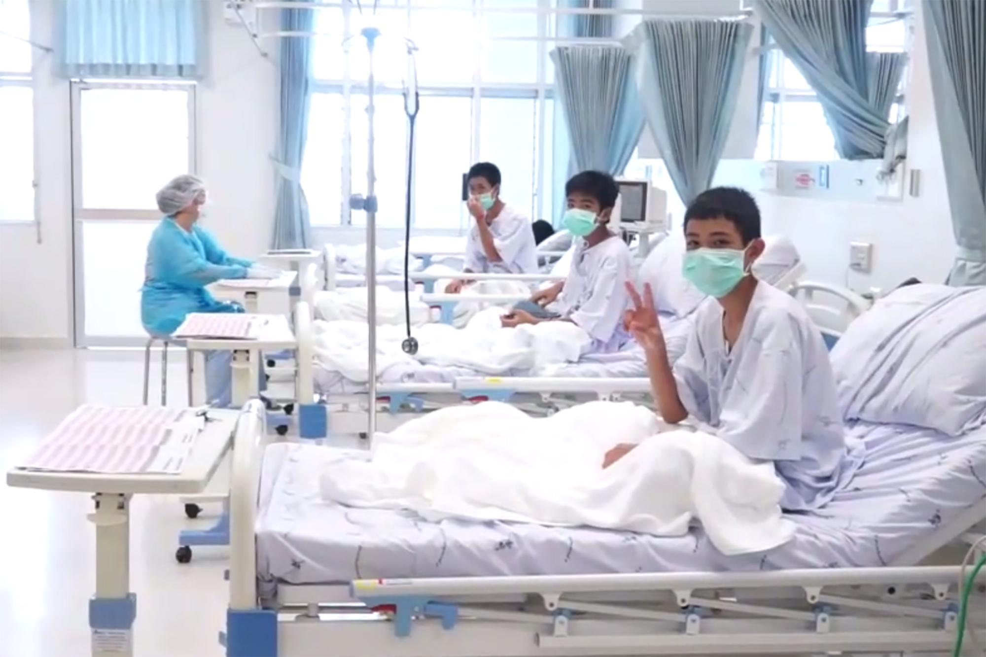 This handout video grab taken from footage released on Wednesday shows members of the Wild Boars football team being treated at a hospital in Chiang Rai. | AFP-JIJI