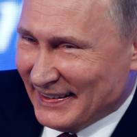 Russian President Vladimir Putin reacts during his annual end-of-year news conference in Moscow last December. | REUTERS