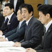Prime Minister Shinzo Abe speaks during a meeting about the recent flooding in western Japan at his office on Saturday. | KYODO