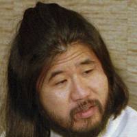 This photo shows doomsday cult leader Shoko Asahara in Bonn, Germany, in 1989. He allegedly told a Tokyo detention house guard to hand his body over to his fourth daughter after he was hanged. | AP